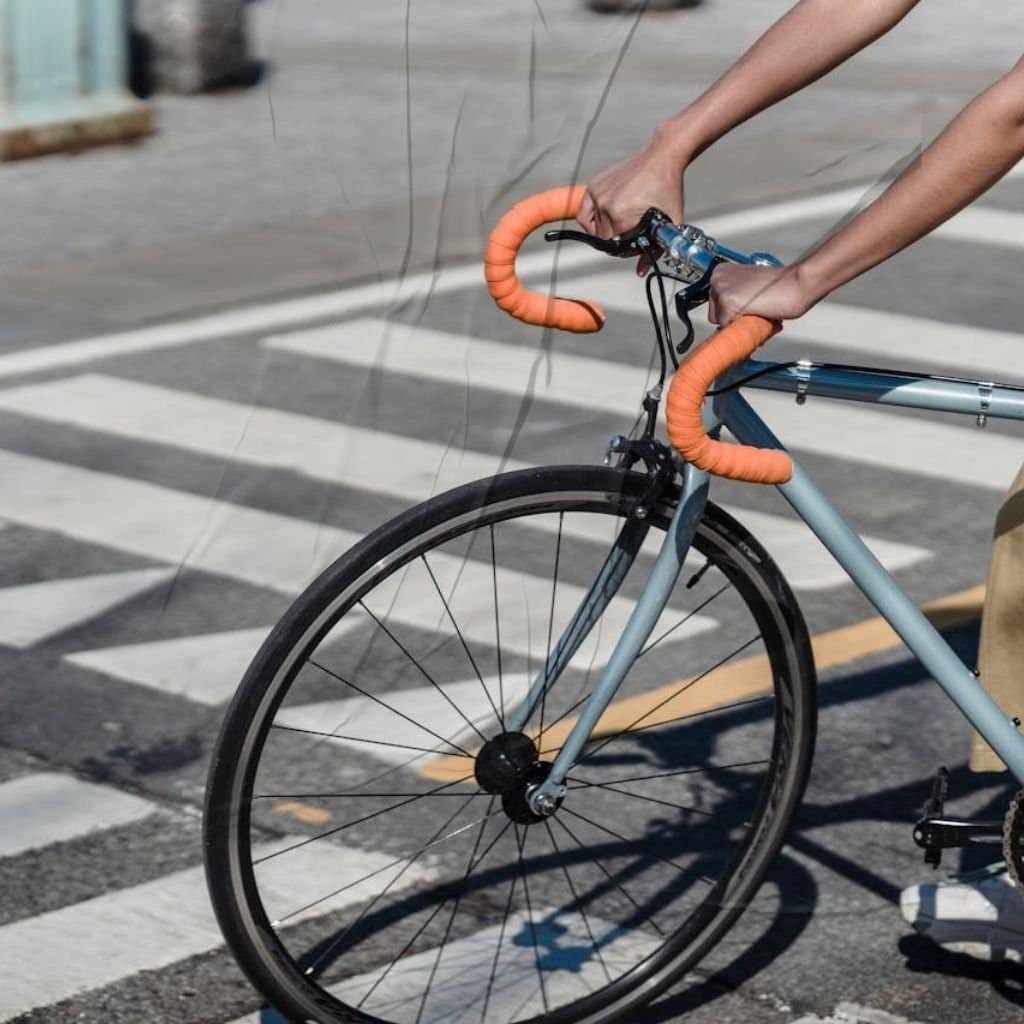 Ethnic woman with Mars in Pisces bike riding on crosswalk